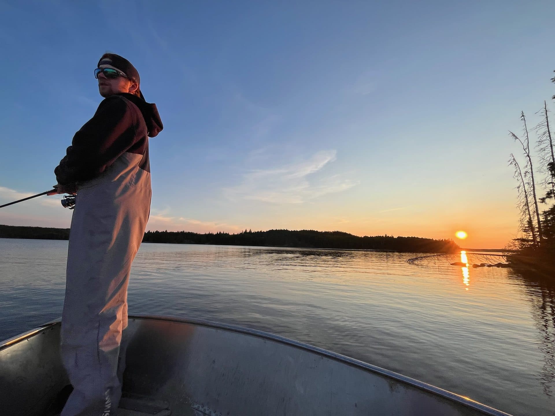 Angler casting at sunset on Dogskin Lake